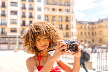 Horizontal photo with copy space of a beauty brunette female tourist taking photos with a camera while visiting a cityの写真素材