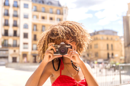 Cute cool and beauty brunette woman taking a photo and smiling visiting a city