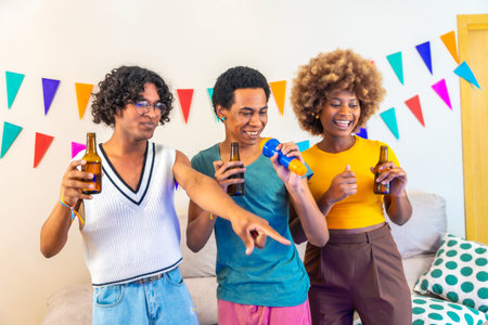 Multi-ethnic male and female friends singing karaoke using microphone and television during party at...