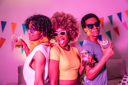 Happy diverse friends laughing partying and drinking alcohol at night with colorful neon light...