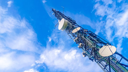 Communication tower with antennas prepared for mobile phones and internet with a blue sky in the...