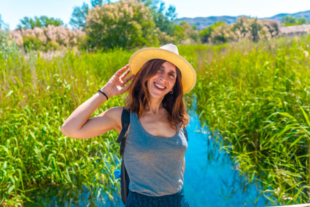 A tourist with a hat in the wetland of the Ojos del Pontil natural park in Rueda de Jalon. Valdejalon. Saragossa. Aragonの写真素材