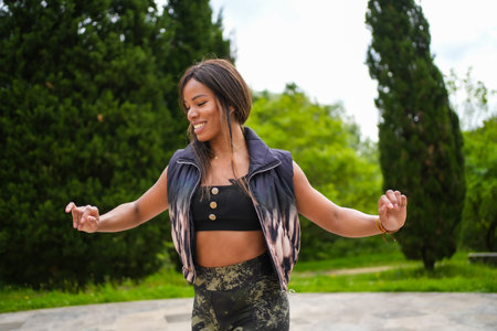 Portrait of a beauty latin delicate woman dancing cuban salsa in a parkの写真素材