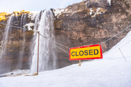 Seljalandsfoss waterfall closed for you to walk under in winter due to snow in Iceland