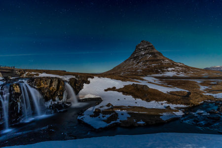 Long exposure of the picturesque Kirkjufell mountain and its beautiful waterfall in the winter of Icelandの写真素材