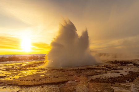 Beautiful eruption of the Strokkur Geyser at sunrise. Iceland's frozen winter is very coldの写真素材