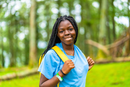 Horizontal close-up portrait of cheerful young african female hikerの写真素材