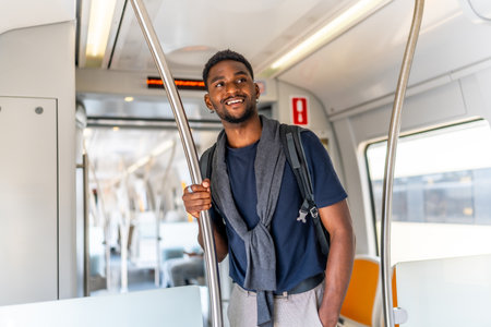 Smiling and casual african businessman traveling by metro in the cityの写真素材