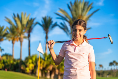 Horizontal close-up portrait of a girl with golf club on shoulderの写真素材