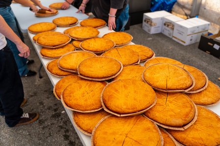 A table full of feet with people standing around it. Scene is one of abundance and sharingの写真素材