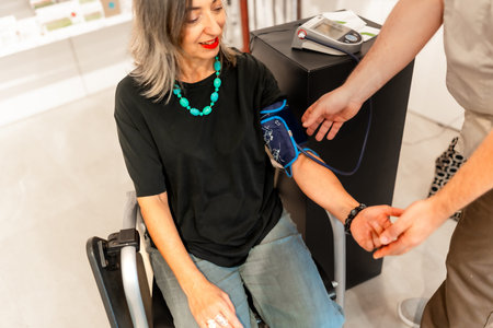 Woman measuring blood pressure assisted by a pharmacist in the store
