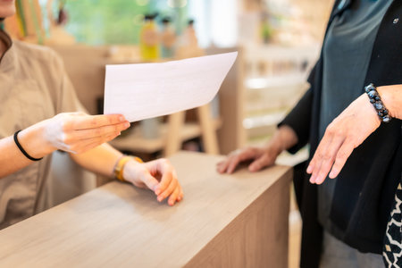 Close-up of a young female pharmacist reading the prescription of a medicine in the storeの写真素材