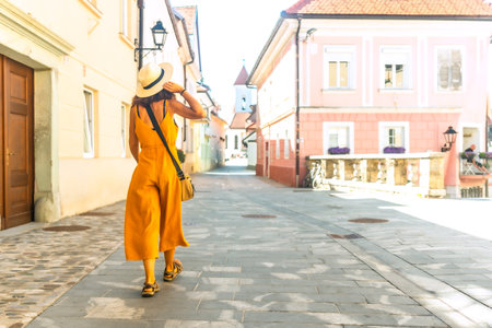 Tourist exploring the charming streets of Kranj, Slovenia, enjoying a summer vacation in Europeの写真素材
