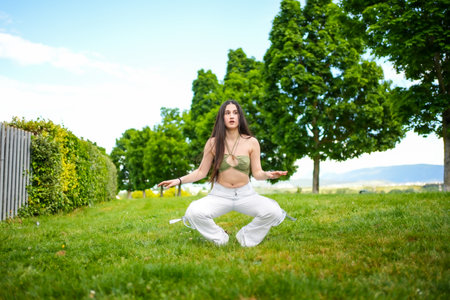 Young athletic caucasian woman crouching in a parkの写真素材