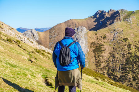 Hiker enjoying the stunning landscape of mount txindoki in gipuzkoa, basque country, on a sunny day