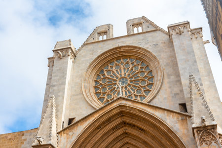 Rose window of the Tarragona cathedral in Catalonia, Spain, exhibiting intricate architectural details and a crossの写真素材