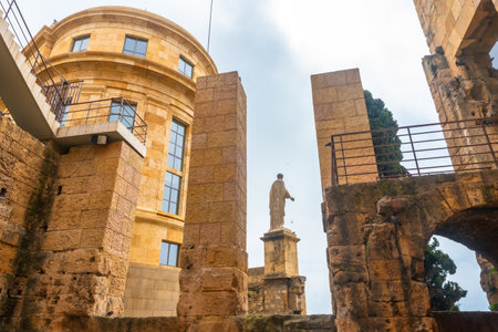 Roman statue standing tall amidst the ruins of Tarragona, showcasing the city's rich historical heritageの写真素材