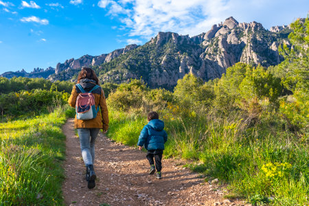 Mother and son enjoying a hike in the montserrat mountains on a beautiful sunny day, surrounded by natureの写真素材