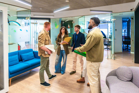 Multi ethnic colleagues brainstorming, sharing ideas, and collaborating on a new project in a...