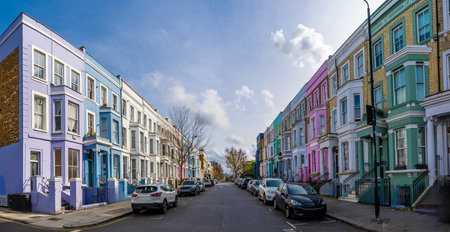 Traditional colorful terraced houses lining a street in Notting Hill, a popular neighborhood in...