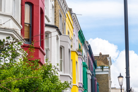 Traditional terraced houses showcasing a vibrant array of colors in the charming neighborhood of Notting Hill, London, creating a picturesque urban landscapeの写真素材