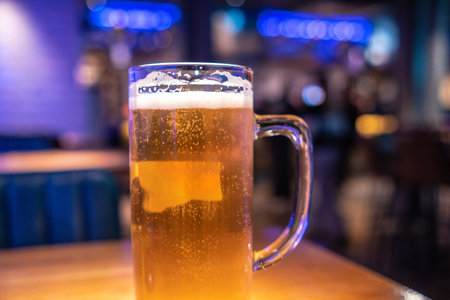 Cold beer waiting on the table in a lively London pub, inviting friends to enjoy a refreshing drink...