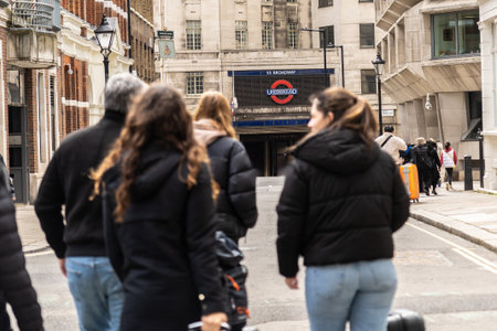 Tourists walking on a London street towards st. Paul's tube station, a major transportation hub in the cityの写真素材
