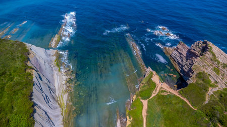 Breathtaking aerial view of the unique flysch rock formations along the coast of Zumaia in the...