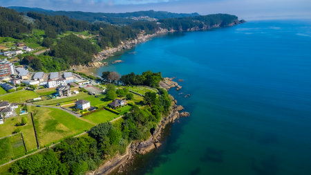 Breathtaking aerial view of Covas beach meeting the Cantabrian Sea, showcasing the stunning coastline of Viveiro, Galicia, Spainの写真素材