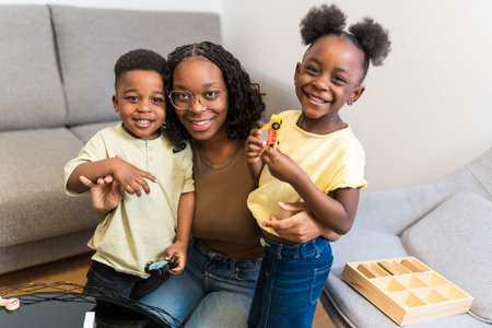 Smiling mother and children playing with toys in living room, enjoying quality family time together