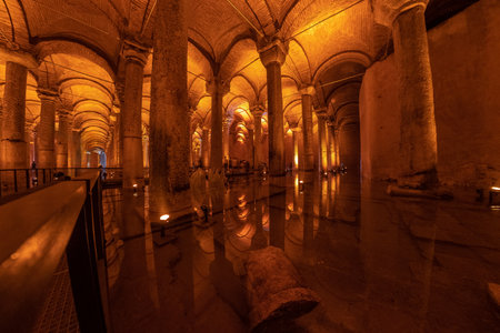 Warm lights illuminating columns and arches reflecting on the water surface of the basilica cistern in istanbul, turkeyの写真素材