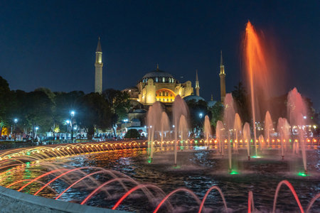 Colorful illuminated fountain jets dancing in front of the Hagia Sophia in Istanbul, Turkey, creating a magical night sceneの写真素材