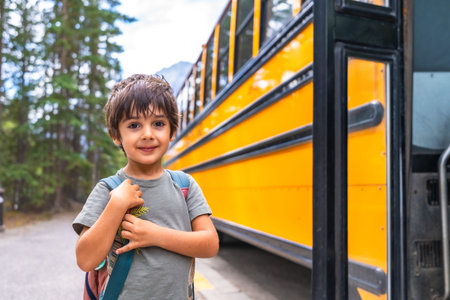 Elementary school student waiting at a mountain road, carrying a backpack and anticipating the...