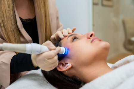 Woman enjoying a rejuvenating hydrafacial treatment with a therapist in a professional aesthetic...
