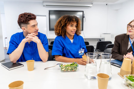 Healthcare professionals and a business person collaborating during a staff meeting, discussing...