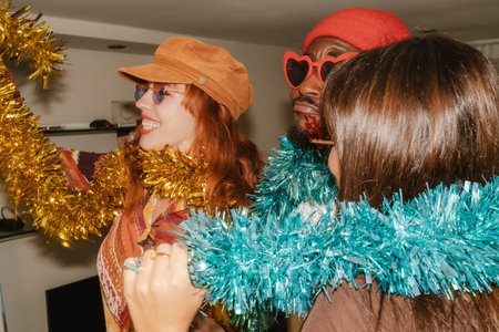 Diverse friends celebrating a party with retro fashion, tinsel garlands, and heart shaped sunglasses, evoking a sense of fun, togetherness, and connection among young adults