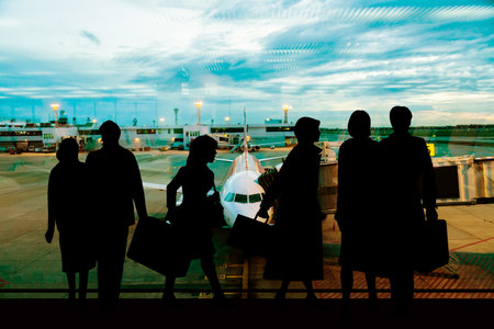 Happy businessman waiting for flight in airport Silhouette of a businessmanの写真素材