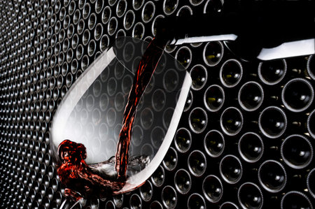 glass with red wine in the winery