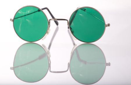 Vintage round sunglasses and their reflection on an isolated white backgroundの写真素材