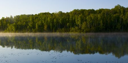 Morning reflecting forest at Deep Water Lake Minnesotaの写真素材