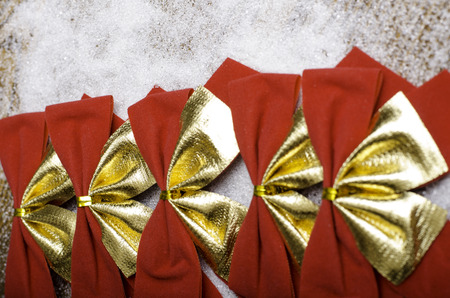 Bright red Christmas bows on a wooden background close-up.の写真素材