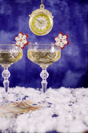 Watches, glasses with champagne and the bill 50 euros. On a blue background.の写真素材