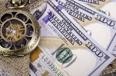 Banknotes hundred dollars, burlap and pocket watches. Close-up.の写真素材