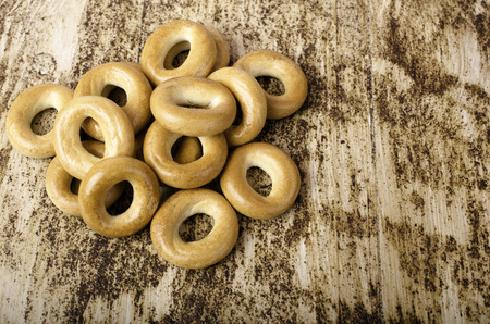 Bunch of bagels horizontally on brown background. Close-up.の写真素材
