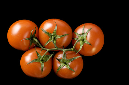 Tomatoes on black background. Close-up.の写真素材