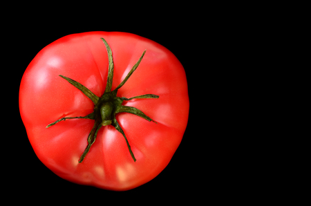 Ripe tomato on a black background. Close-up.の写真素材