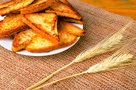 Delicious fried toast on a white plate. On  sackcloth.