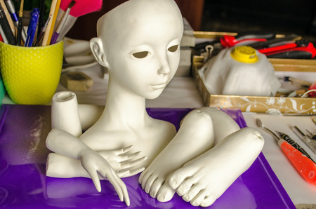 The process of making dolls. Different parts of the doll on the working surface.の写真素材