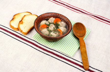 Easy diet soup with white round meat meatballs. With carrots, dill, on a linen napkin.の写真素材