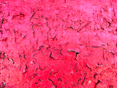Bright background of an old cracked wall painted with pink paint.の写真素材